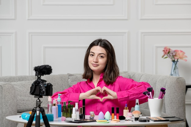 Make-up Blogger ziemlich niedlich Brünette junges Mädchen Aufnahme Blog vor der Kamera mit Liebeszeichen