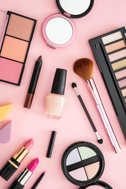 Make-up-Kosmetika gegen einen rosa Hintergrund