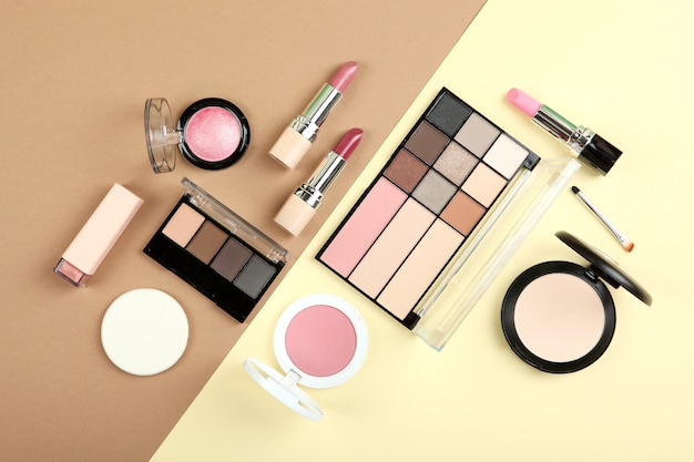 Make-up-Produkte auf der Draufsicht des farbigen Hintergrunds