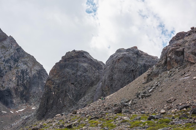 Malerische Berglandschaft mit zwei großen Steinhügeln unter bewölktem Himmel Schöne Berglandschaft mit zwei großen Steinhügeln bei bewölktem Wetter Ehrfürchtiger Alpenblick auf zwei felsige Hügel unter Wolken