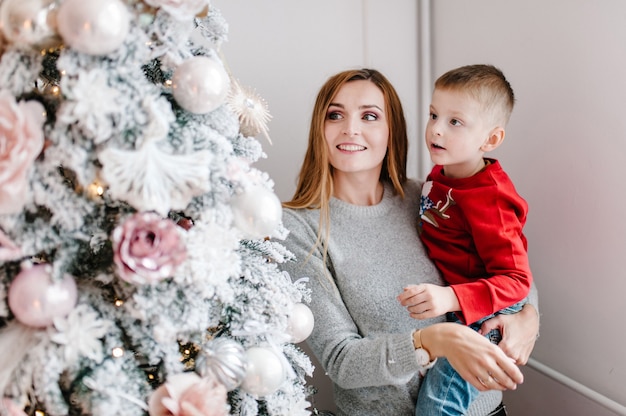 Mamá, abrazar, hijo, cerca, árbol de navidad