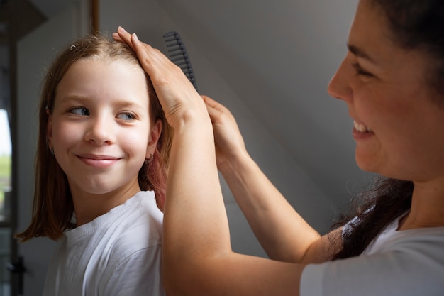 Mamá cuidando el cabello de su hija