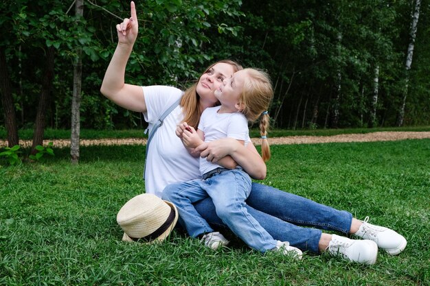 Mamá e hija en el parque en el césped