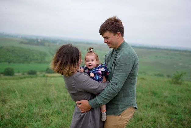 Mama, Papa und Tochter. Eltern umarmen und küssen sich