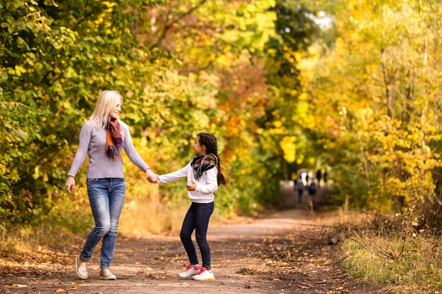 Mamá con su hija durante el otoño