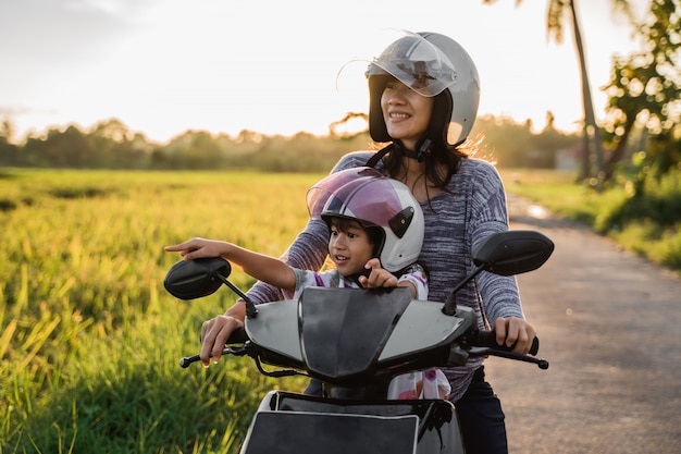 Mamá y su hijo disfrutan andar en moto