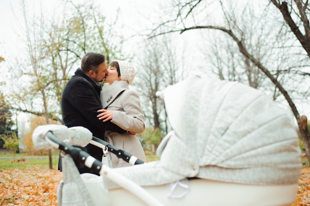 Mamãe e papai abraçando no parque outono