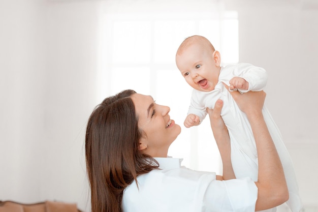 Mamãe segura o bebê nos braços em casa