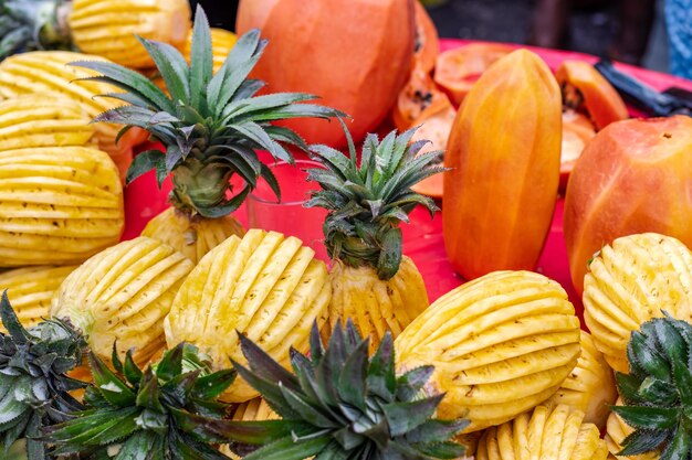 Mamão e abacaxi com design ornamental em um mercado de frutas