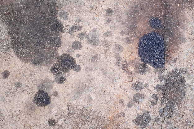 Manchas de aceite de motor de los automóviles que gotean en el piso del estacionamiento aceite de motor de automóvil piso de cemento suciedad vieja vista superior