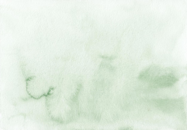 Foto manchas de acuarela verde sobre textura de fondo blanco. fondo líquido verde claro, pintado a mano.