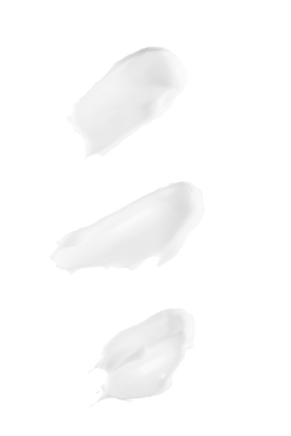 Manchas de creme branco isoladas no fundo branco