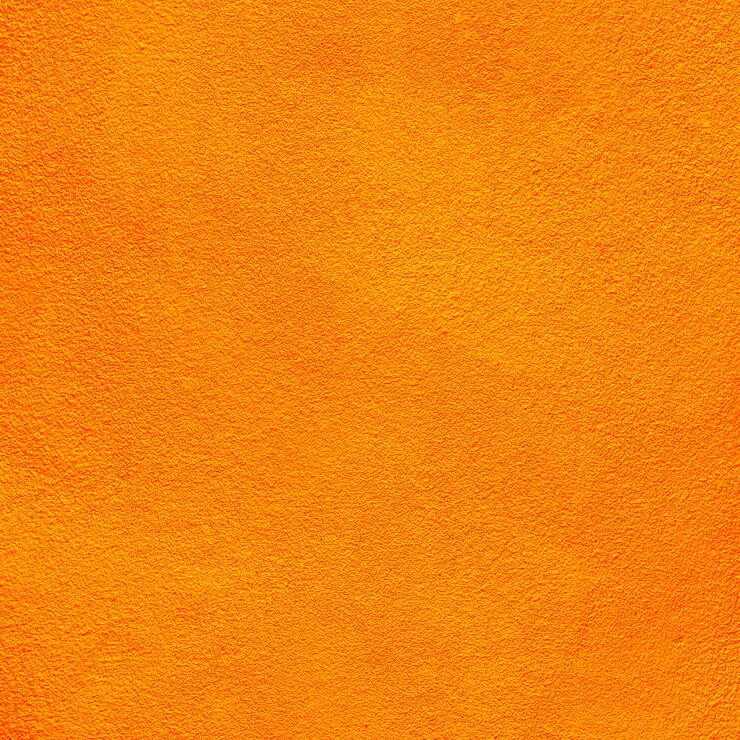 Foto mandarina de color sobre fondo de textura de pared