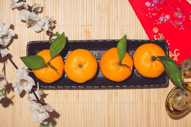 Foto mandarinas y año nuevo lunar con el texto 