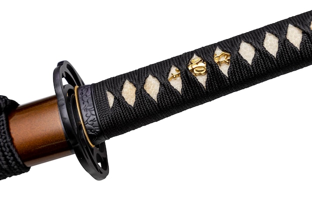 Mango tsuka de espada japonesa envuelto por cordón de seda negra sobre piel de raya blanca aislada en fondo blanco Enfoque selectivo
