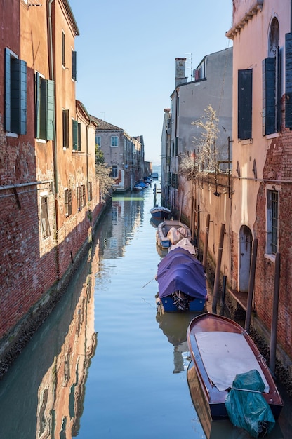 Manhã em canais de água de Veneza ao longo da paisagem urbana de edifícios residenciais