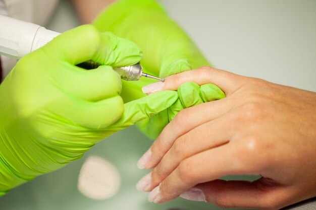 Manicura SPA, mujer en un salón de manicura recibiendo una manicura