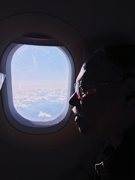 Mann am Fenster im Flugzeug