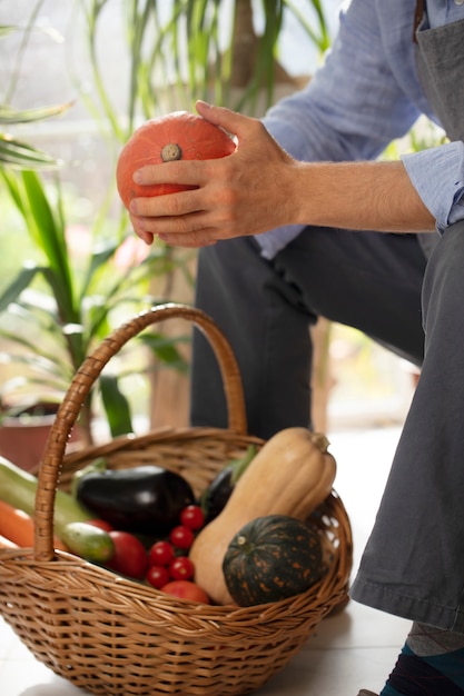 Foto mann, der gemüse in seinem indoor-garten anbaut