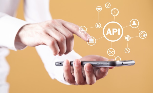 Mann, der Smartphone hält. API. Programmierschnittstelle. Software-Entwicklung. Technologie