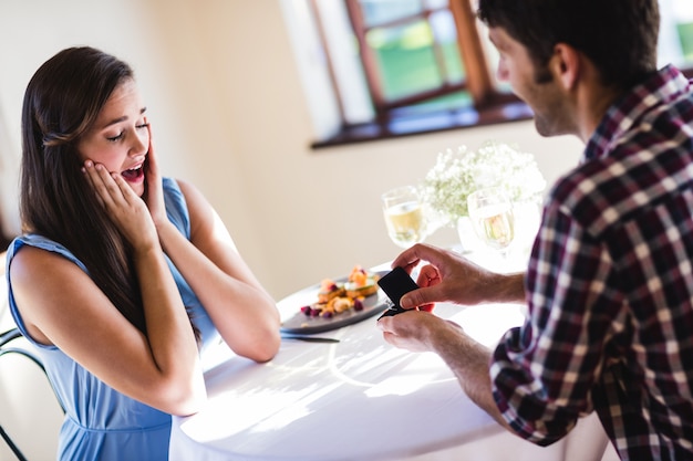 Mann, der zur Frau in einem Restaurant vorschlägt