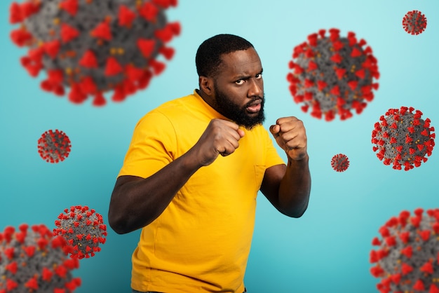 Mann greift mit einem Schlag das Coronaviru an