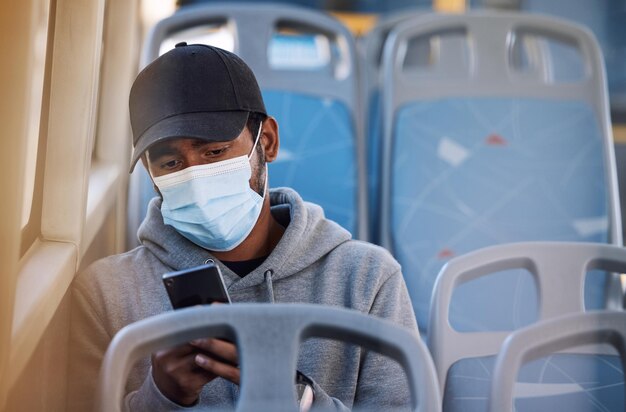 Mann im Bus mit Maske, Telefon und morgendlicher Fahrt in der Stadt, Service-Zeitplan oder Social-Media-Post, Sicherheit des öffentlichen Verkehrs im COVID-Stadtverkehr und Person im Sitz mit Smartphone-Verbindung