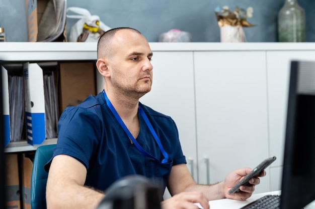 Mann in medizinischer Uniform, der mit Computertechnologien arbeitet. Modernes digitales Gesundheitswesen im Krankenhaus.