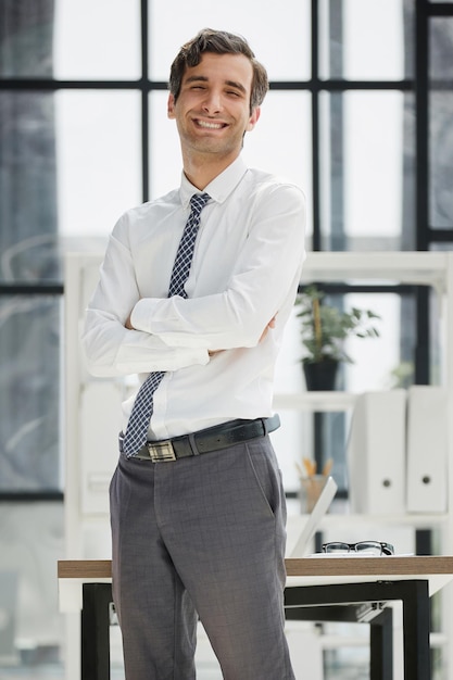 Mann lehnt sich während eines Telefongesprächs im Büro auf den Tisch