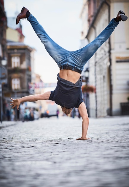 Mann macht einen Handstand in der Stadt