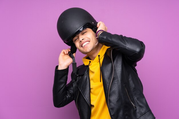 Mann mit einem Motorradhelm lokalisiert auf lila Hintergrund