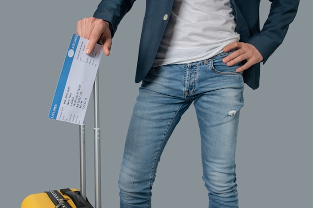 Mann mit Flugticket und Koffer