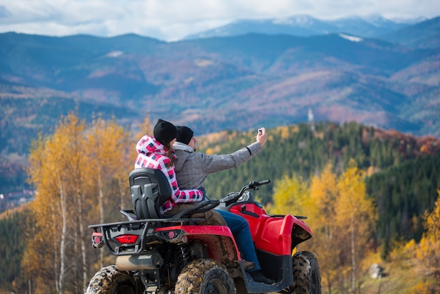 Mann mit Frau auf rotem Quad Fahrrad