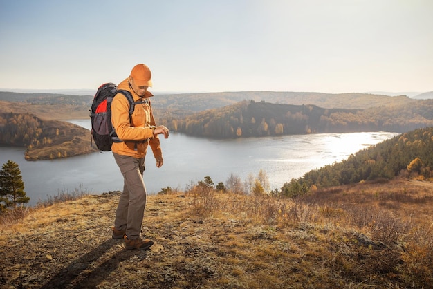 Mann reist mit Rucksack Wandern in Bergen in der Nähe wie bei Sonnenuntergang Lifestyle Erfolgskonzept Abenteuer Aktivurlaub im Freien