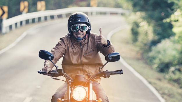 Mann Reiten Motorrad auf einer Straße in Freiheit Lebensstil zur Urlaubszeit