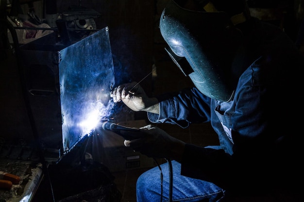 Mann schweißt Metall in der Werkstatt