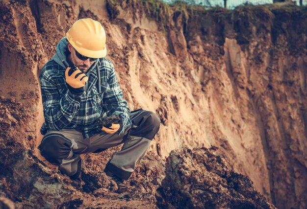 Foto mann sitzt auf einem felsen