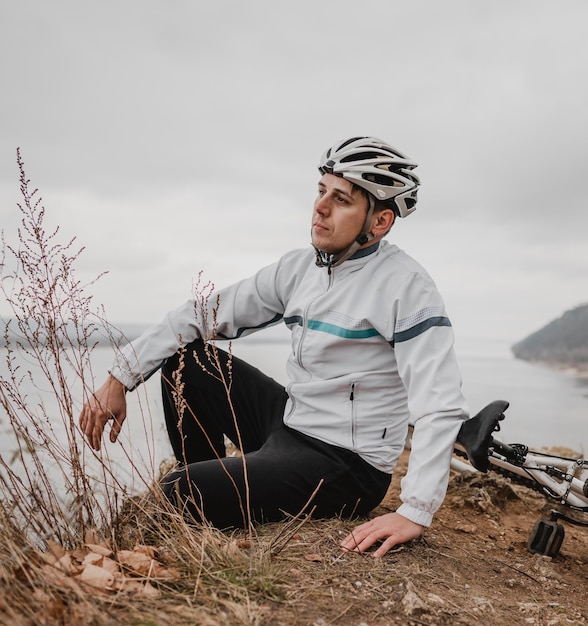 Foto mann sitzt neben seinem mountainbike