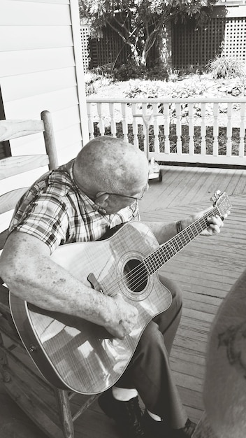 Foto mann spielt gitarre auf der veranda