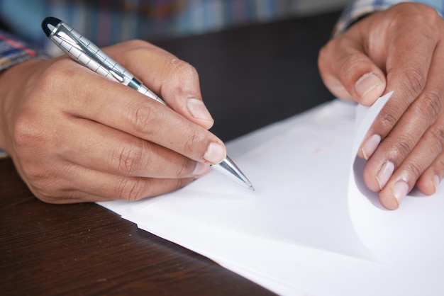 Mannhand in Füllfederhalterschrift oder Unterschrift auf Papier