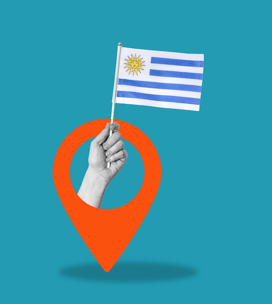Mano de collage de arte con la bandera de Uruguay en fondo azul con una señal de navegación