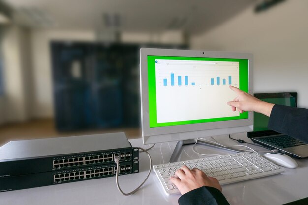 Mano cortada de una mujer de negocios usando una computadora en la mesa