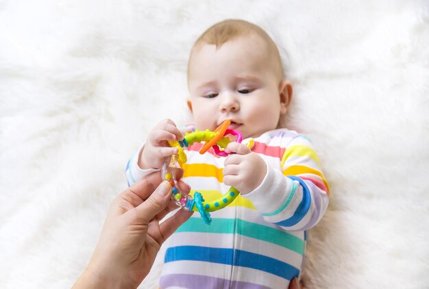 Foto mano cortada de una niña jugando con juguetes en la mesa