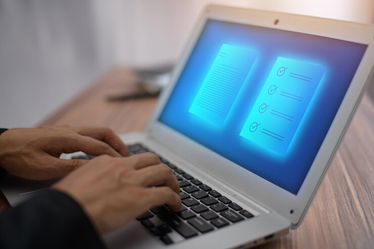 Foto mano cortada usando una computadora portátil en la mesa