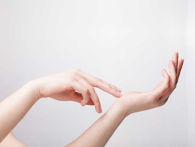 Mano cuidada femenina midiendo elementos invisibles, palma de la mujer haciendo gesto