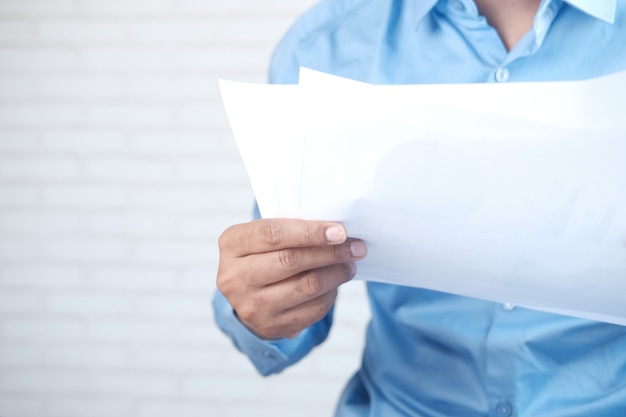 Foto mano de hombre sosteniendo papel leyendo algo