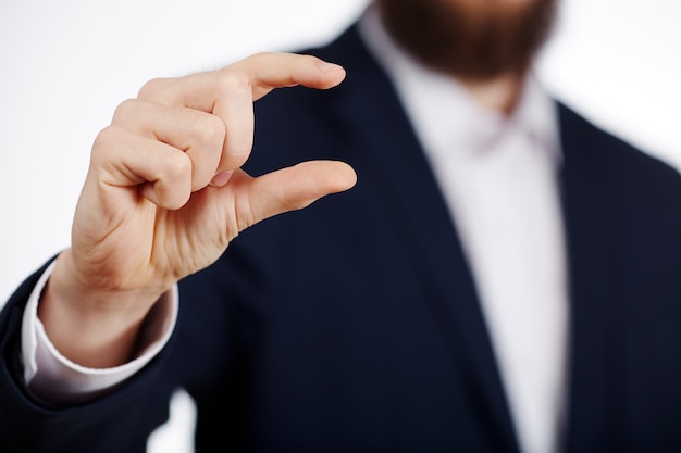 La mano del hombre con traje mostrando un cartel en el estudio