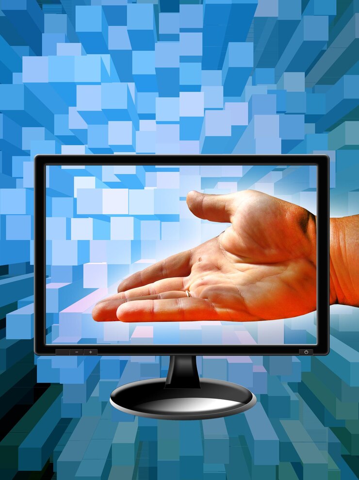 Foto mano humana con un monitor moderno en un fondo azul abstracto