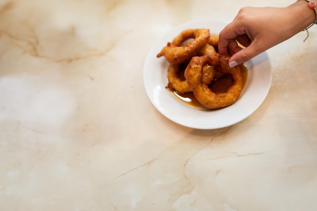 La mano de una mujer recoge un plato sobre una mesa de mármol Copia espacio comida peruana