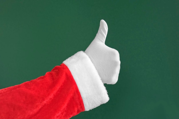 Mano de Papá Noel que muestra los pulgares hacia abajo Gesto aislado sobre fondo verde Primer plano No me gusta No me gusta Chroma Key Pantalla Lenguaje corporal Mano enguantada blanca Haciendo signo negativo Mal comportamiento